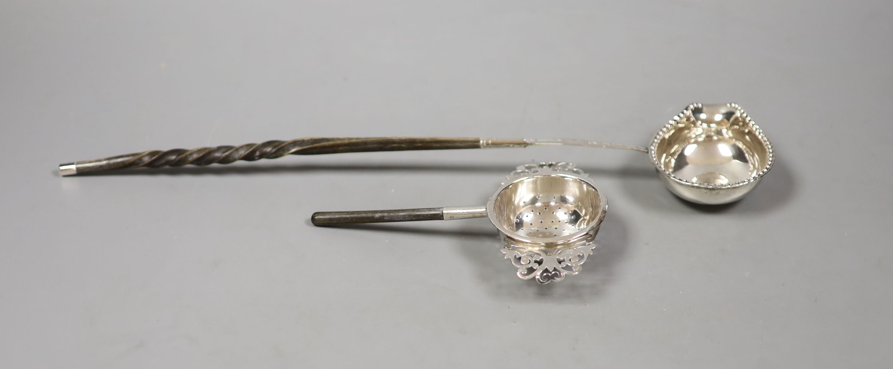 A straining ladle, Sheffield, 1909 by Harrison Brothers & George Howson, together with a coin set toddy ladle.